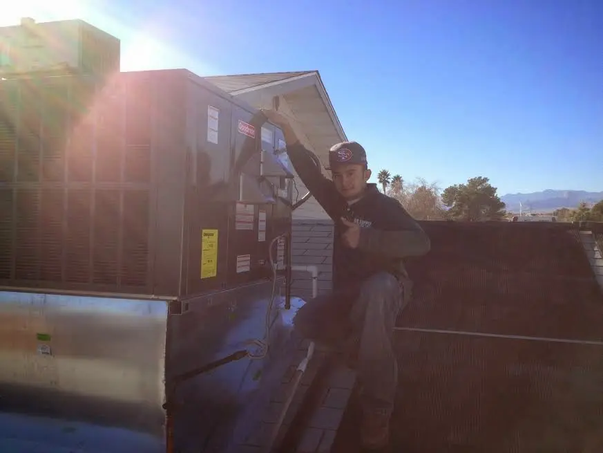 HVAC technician performing Air Duct Repair on a rooftop unit in Chillicothe